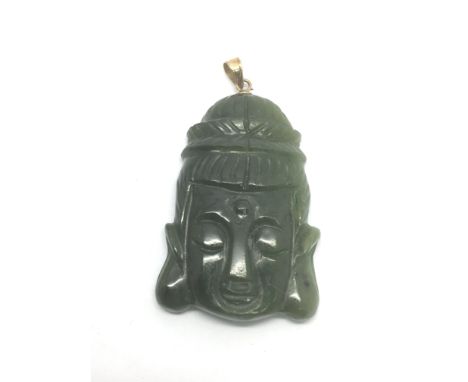 A jade pendant in the form of a Buddha head with 14k clasp - NO RESERVE