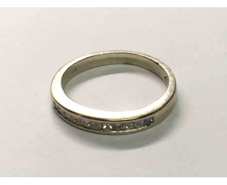 An 18carat gold half hoop eternity ring set with princess cut diamonds. Ring size I
