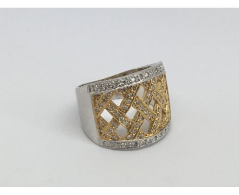 An 18ct white and yellow gold ring set with diamonds in a criss cross setting, approx .50ct, approx 10.5g and approx size P.