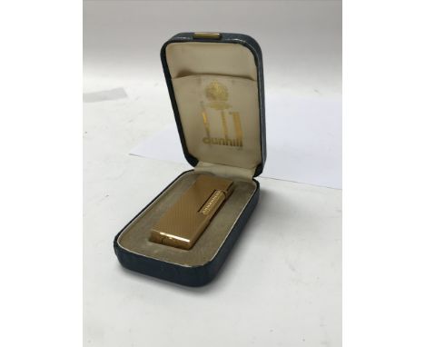 A gold plated Dunhill lighter in original box .