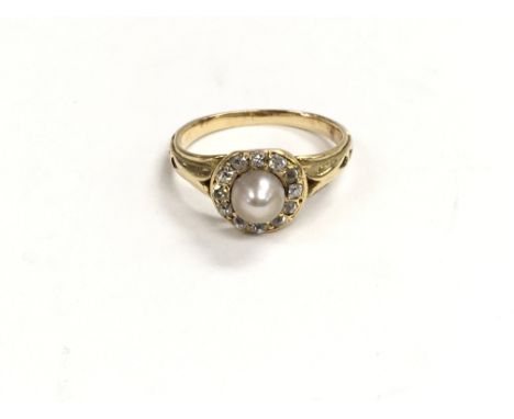 An unmarked ring set with a pearl and surrounded by white sapphires. Ring size is approximately between j and k.