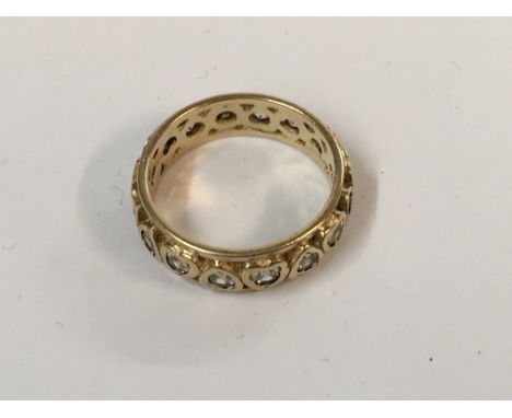 A 9ct gold eternity ring set with white stones. ( 2 stones missing).