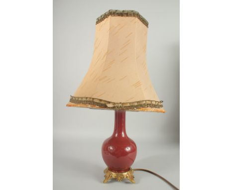 AN 18TH CENTURY CHINESE COPPER RED PORCELAIN VASE, converted to a lamp with ormolu mounts, shade included, vase 23cm high.