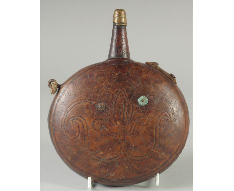 A 19TH CENTURY ISLAMIC OTTOMAN LEATHER FLASK, 18cm wide.