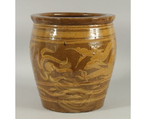 A CHINESE EARTHENWARE GLAZED POTTERY JARDINIERE PLANTER, decorated with dragon, 30cm high.