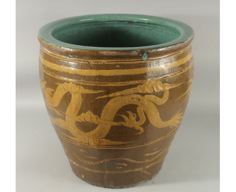 A VERY LARGE CHINESE EARTHENWARE GLAZED POTTERY JARDINIERE PLANTER, decorated with dragon, the interior with turquoise glaze,