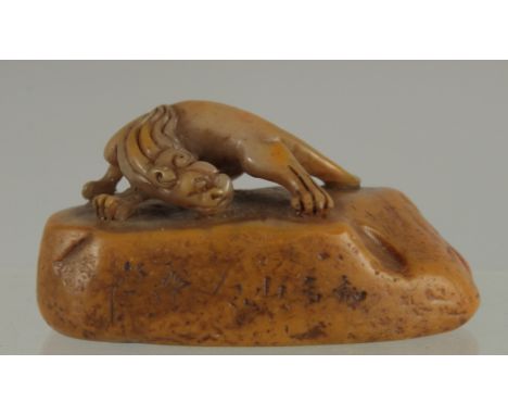 A 19TH CENTURY CHINESE SOAPSTONE SEAL, with carved chilong, 8.5cm long.