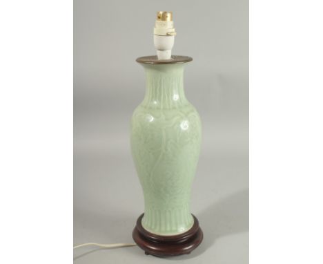 A CHINESE CELADON GLAZE PORCELAIN LAMP VASE, mounted to a hardwood base, (fitted for electricity but untested), shade include