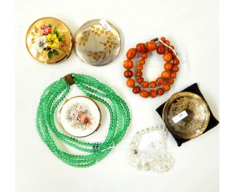 Quantity of costume jewellery to include a glass necklace, amber-style beads, compacts, a leather jewellery box without key a