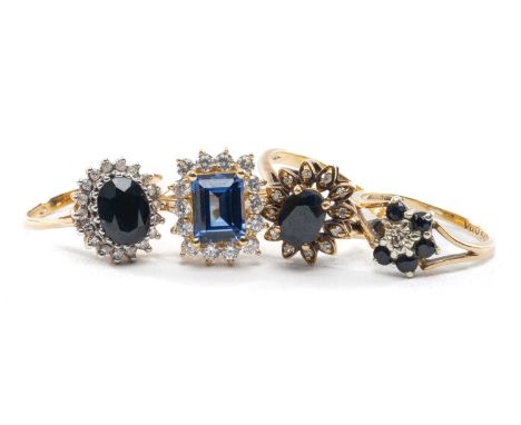 FOUR 9CT SAPPHIRE RINGS, comprising emerald-cut and cz halo, dark oval-cut and diamond halo, old oval-cut diamond flower clus
