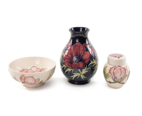 THREE PIECES OF MOORCROFT TUBELINED POTTERY comprising Anemone vase, candlestick cypher for 1992, 19cms high, pink magnolia o