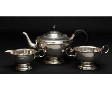 GEORGE VI SILVER THREE PIECE TEA SERVICE Birmingham 1937, comprising teapot, sucrier and cream jug, of circular pedestal form