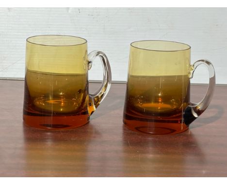 A pair of vintage amber glass mugs.