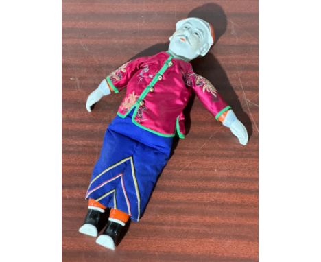 A Chinese porcelain doll. 42cm
