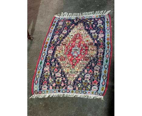 A vintage hand knotted rug. 78x119cm