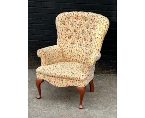 A deep button back armchair.