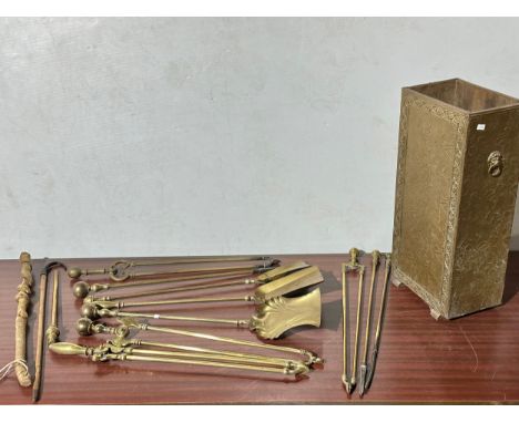 Brass fire tools and an umbrella stand.