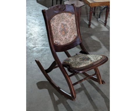A vintage folding rocking chair