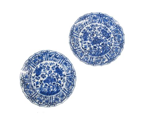 A Pair of Chinese Porcelain Plates, Kangxi, of barbed circular form, painted in underglaze blue with a flowering tree in a fe