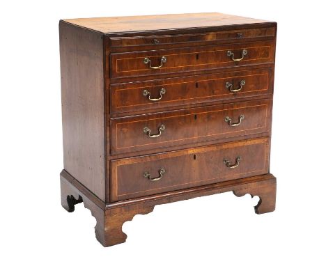 A George II Figured Walnut and Boxwood-Strung Straight-Front Chest of Drawers, circa 1740, the moulded top above a pull-out b