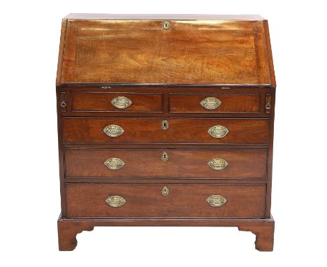 A George III Mahogany Bureau, late 18th century, the fall front enclosing a good fitted interior of six drawers, pigeon holes