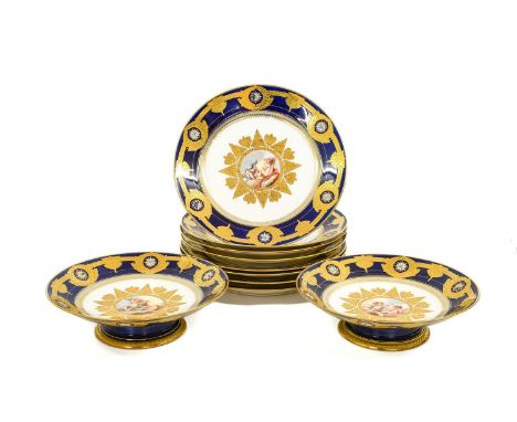 A Sèvres-Style Porcelain Dessert Service, circa 1900, decorated with putti within gilt cartouche on a blue ground with white 
