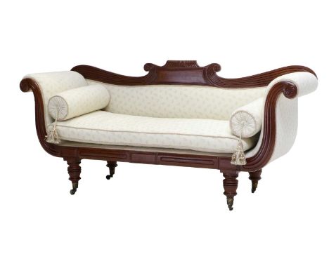 A Regency Style Carved Mahogany Scroll End Sofa, late 19th century, recovered in cream leaf pattern fabric, the reeded frame 