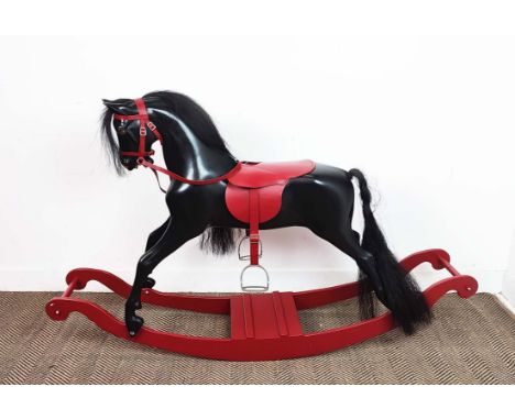 HADDON ROCKING HORSE, ebonised and red leather, 103cm H x 35cm W x 151cm L.