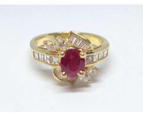 A ruby and diamond cluster ring, the central ruby weighing approx. 1ct, surrounded by baguette, princess and marquis cut diam
