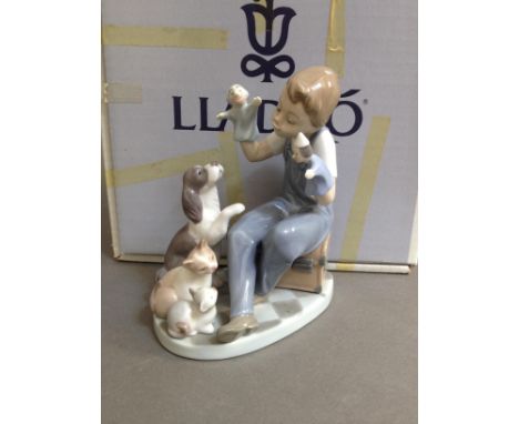 A Lladro figure, "Puppet Show", no. 5736, height 15cm, with box.  Condition damage/repair free.