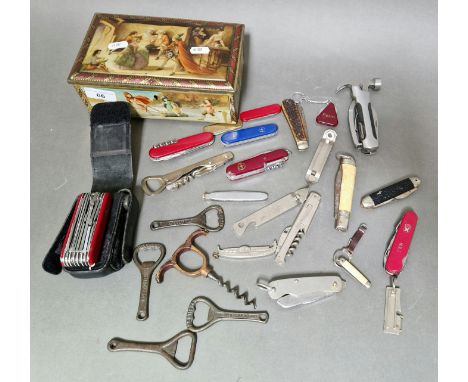 A lidded tin box containing vintage & modern penknifes, bottle openers & corkscrews to include Victorinox swiss army tools et