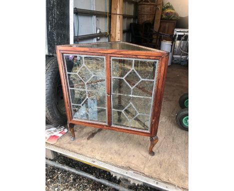 Glazed corner cabinet with stick on lead on panels on pad feet with one shelf inside 31 inches wide 34 tall