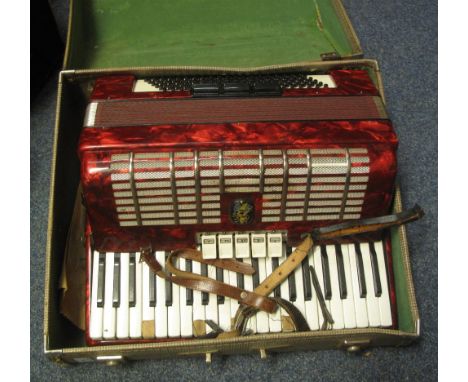 Red mother of pearl finish piano accordion in carrying case.(B.P. 24% incl. VAT)