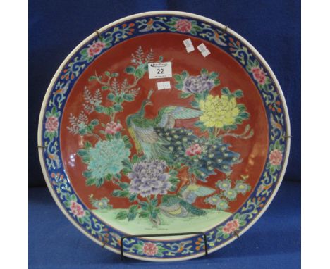 Chinese porcelain red ground charger overall with enamel decoration depicting peacock amongst chrysanthemums. Unmarked, 41cm 