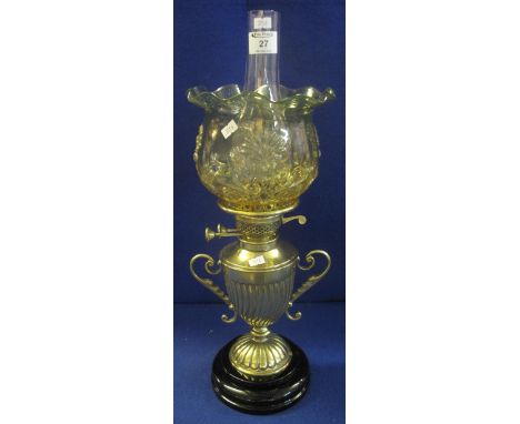 Brass double burner oil lamp with half lobed two handled urn shaped brass base on ceramic support, coloured glass shade with 