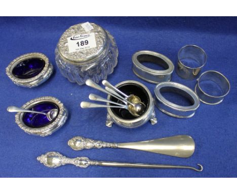 Assorted items of silver to include: condiments, napkin rings, pair of open repousse salts with blue glass liner, another sal