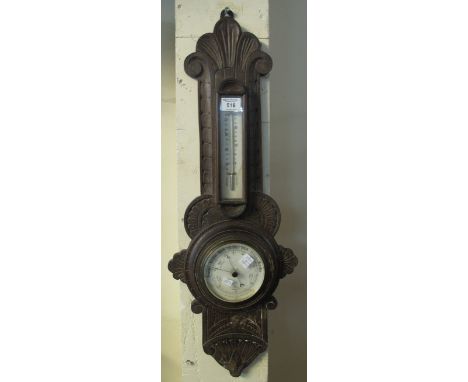 Early 20th Century carved oak aneroid barometer.(B.P. 24% incl. VAT)