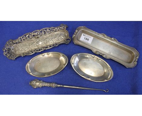 Assorted silver items to include: two silver hat pin trays, pair of oval silver dishes and a silver handled button hook. (B.P