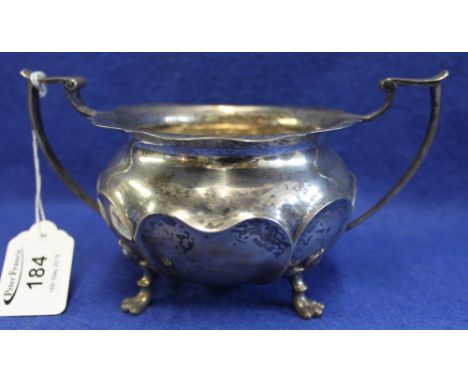 Early 20th Century silver two handled sucrier with repousse panels on four paw feet. Sheffield hallmark. 11 oz approx. (B.P. 