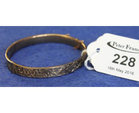 9ct gold hollow engraved and hinged bangle(B.P. 24% incl. VAT)   CONDITION REPORT:  Quite badly dented in a number of places.