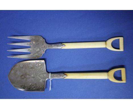 A pair of silver plated novelty fork and spade fish servers, having ivory handles, 19cm. Condition Report: Surface scratching