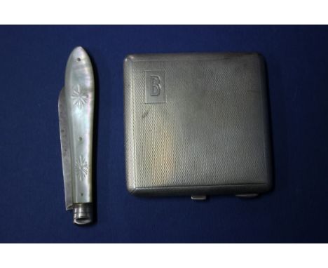 An engine turned silver compact and a silver bladed fruit knife.