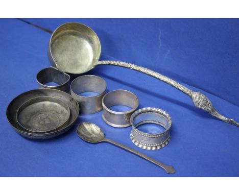 Four various silver napkin rings and a teaspoon, 102g; together with a metal ladle and two other metal items.