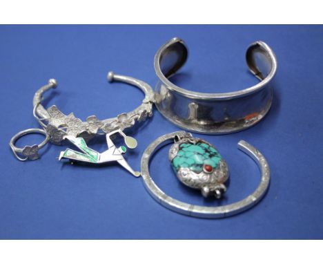 A Tibetan silver torque bangle with matching ring; together with four other items of white metal jewellery.