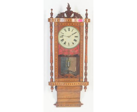 A 19th century large Vienna regulator wall clock. The large decorative walnut case with glass window enclosing brass movement