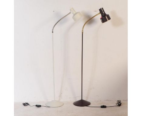 Two vintage standard floor standing light / lamps. Both similar and having single spot lights on adjustable goose neck suppor