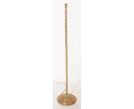 A mid 20th century brass floor standing lamp / light. With brass light fitting, over full barley twist shaft raised upon a ci