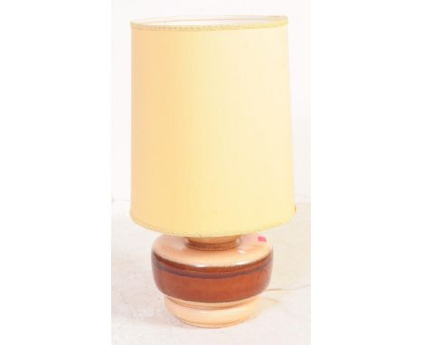 A vintage mid 20th century West German pottery table lamp light. Of bulbous form with brown earth tone to body, on circular b