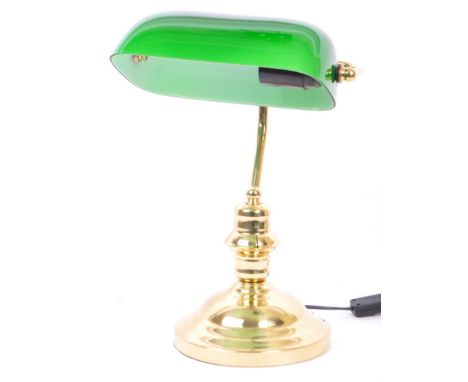 A vintage 20th Century bankers office table lamp light. Having a green glass swinging shade, with brass reeded support on a s