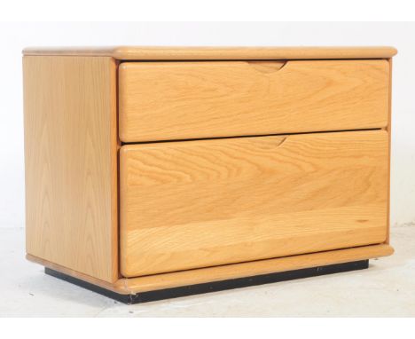 Hulsta - A 20th century vintage Hulsta light beech bedside cabinet. The cabinet having a bank of twin drawers each with lippe